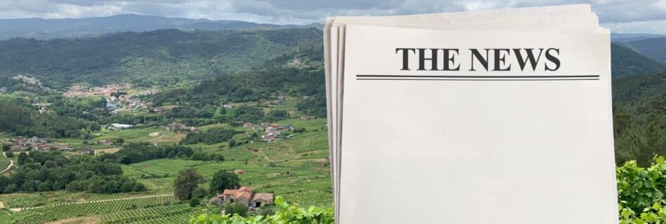 a newspaper graphic over a background of a Galician wine landscape