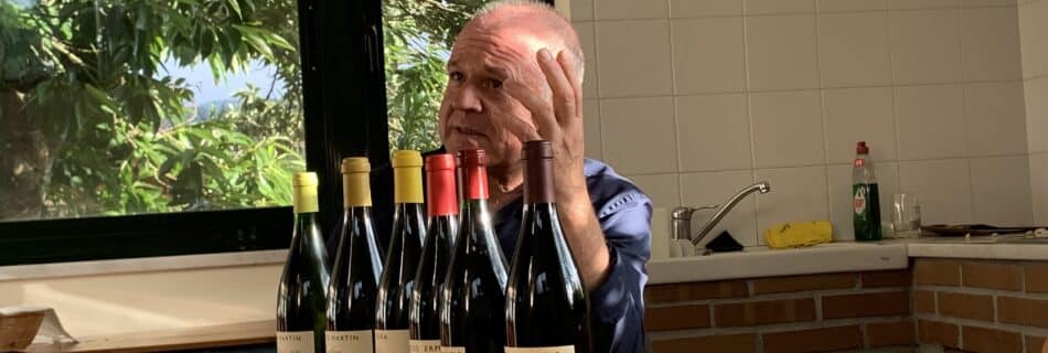 Luis Anxo Rodríguez Vázquez sitting at a table with bottles of Ribeiro wine